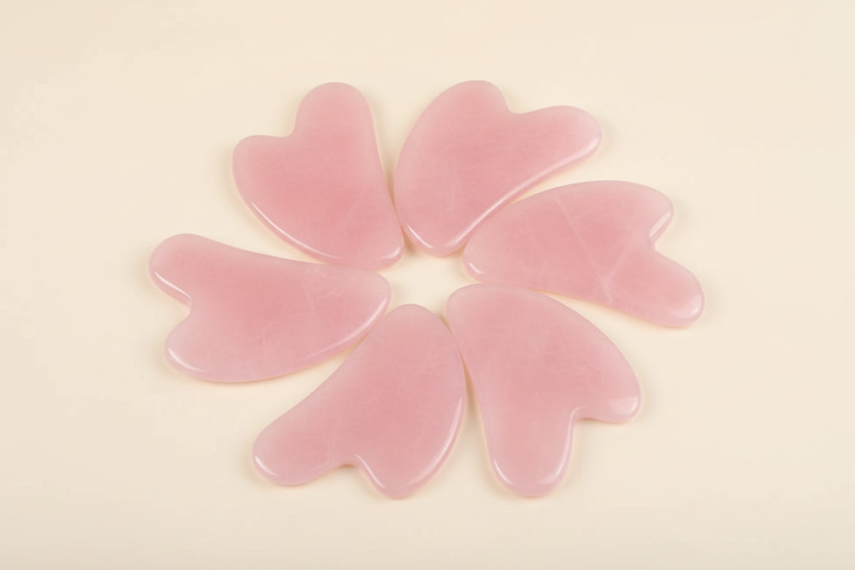 Pink heart-shaped objects on a blue background with a white flower.